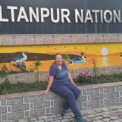 A picture of myself at the entrance of Sultanpur, which has a beautiful birding mural.